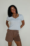 Woman wearing a ribbed light blue tee