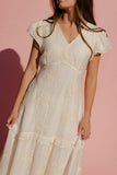 Woman wearing a white dress against a pink background