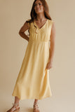 Woman wearing a yellow dress against a beige background