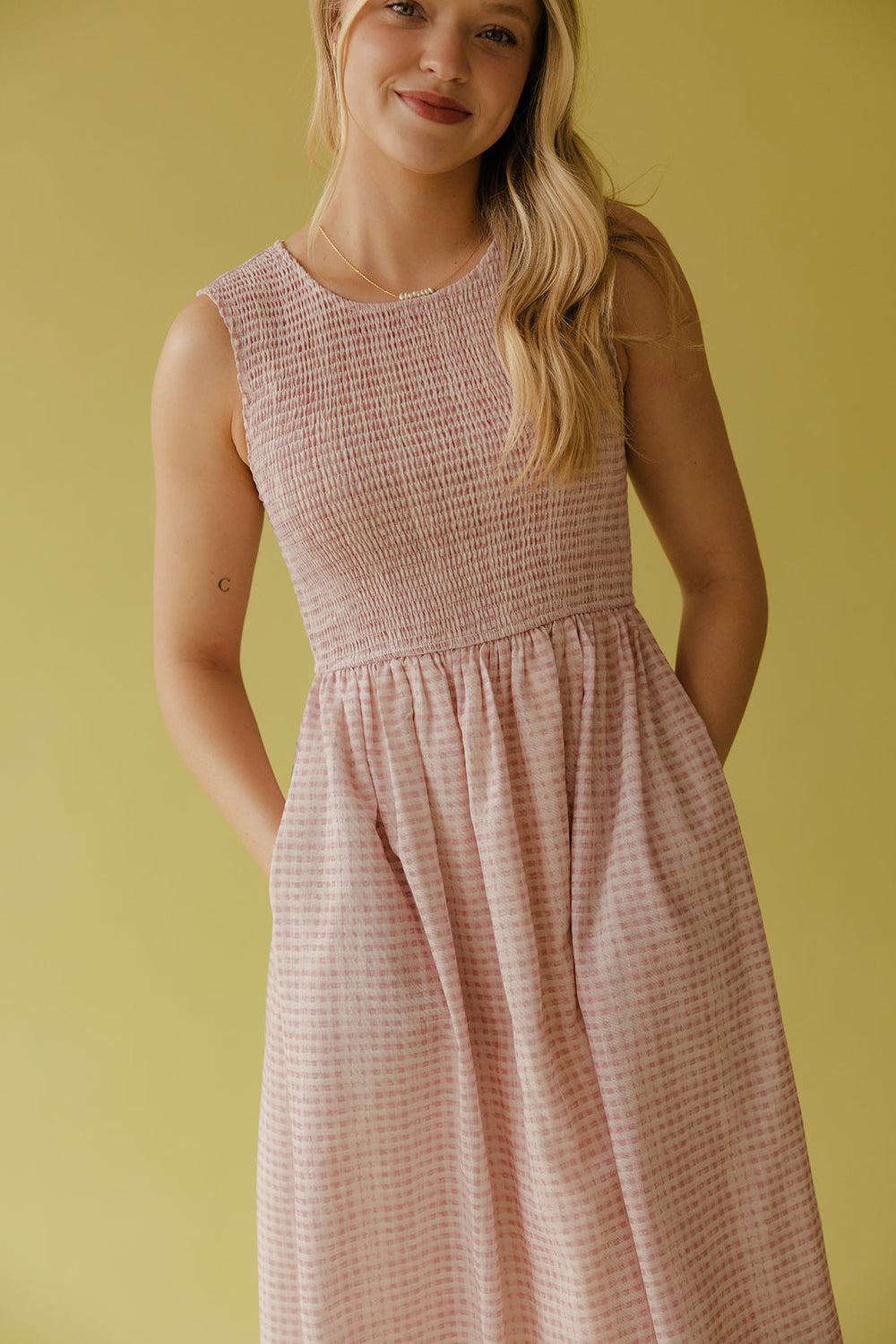 Woman wearing a pink gingham dress
