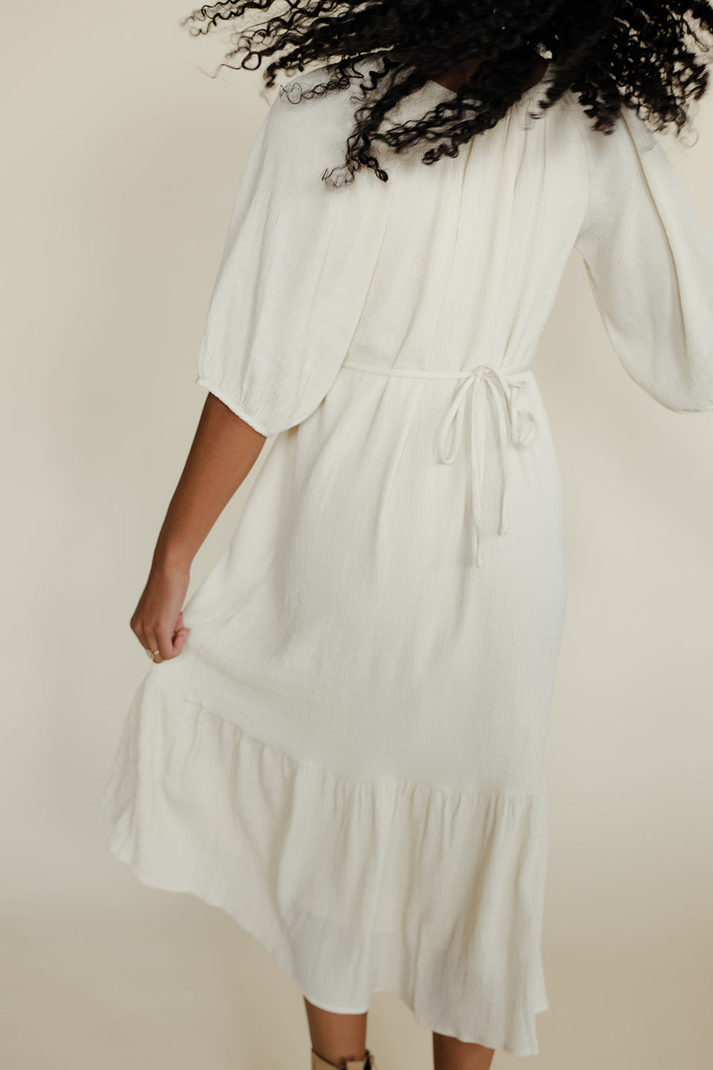 White dress worn by a person against a plain background