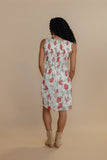 Woman wearing a floral dress against a beige background