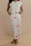 Person wearing a white patterned skirt and sleeveless top against a beige background