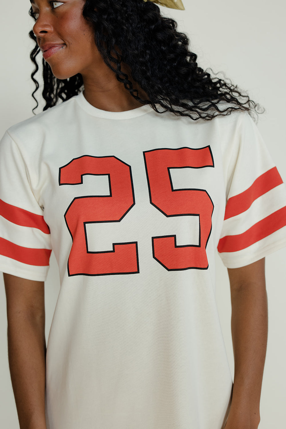 Person wearing a white jersey with red numbers