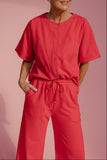 Person wearing a red outfit against a pink background