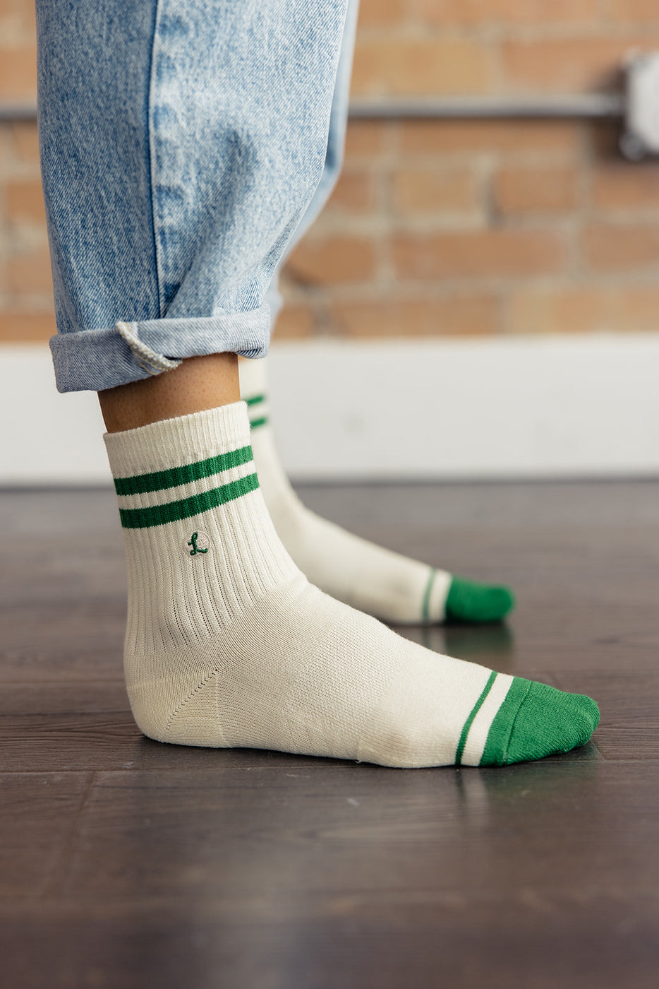 a person wearing white and green socks