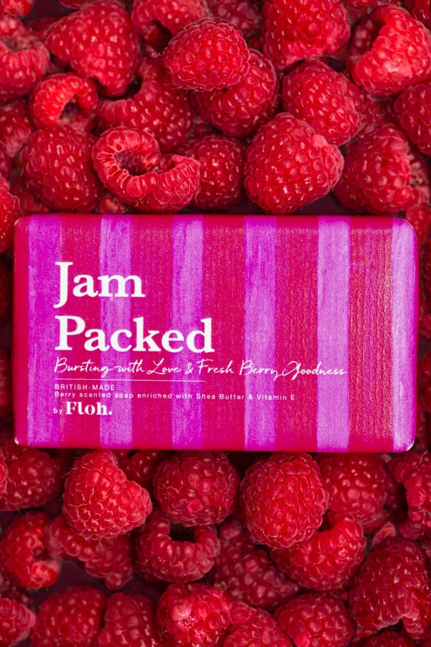 Bar of soap labeled 'Jam Packed' surrounded by raspberries