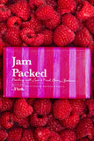 Bar of soap labeled 'Jam Packed' surrounded by raspberries