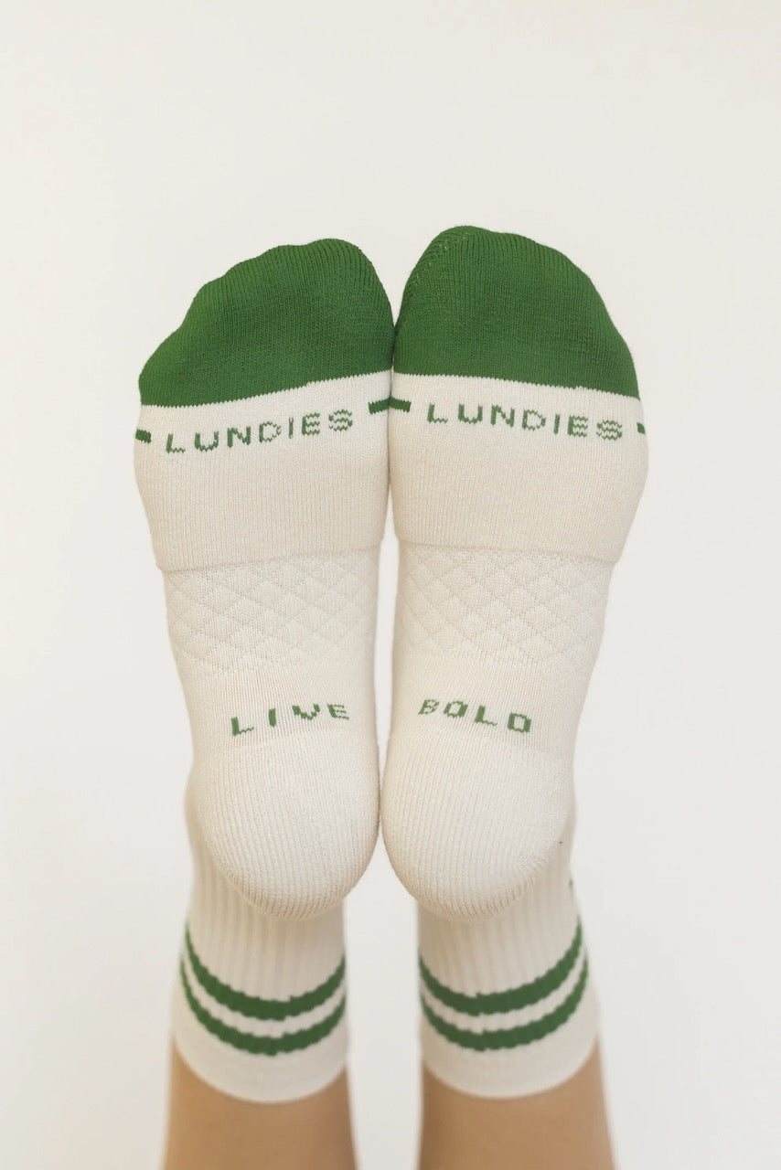 a pair of white and green socks with green text