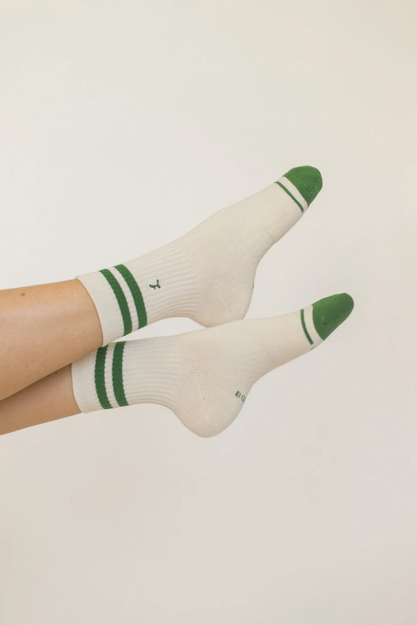 a pair of feet with green and white socks