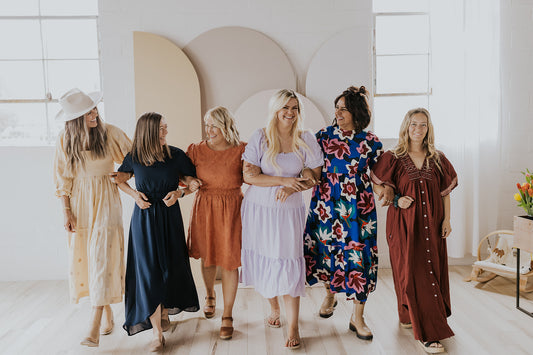 A group of moms styling ROOLEE, and walking with their arms linked together