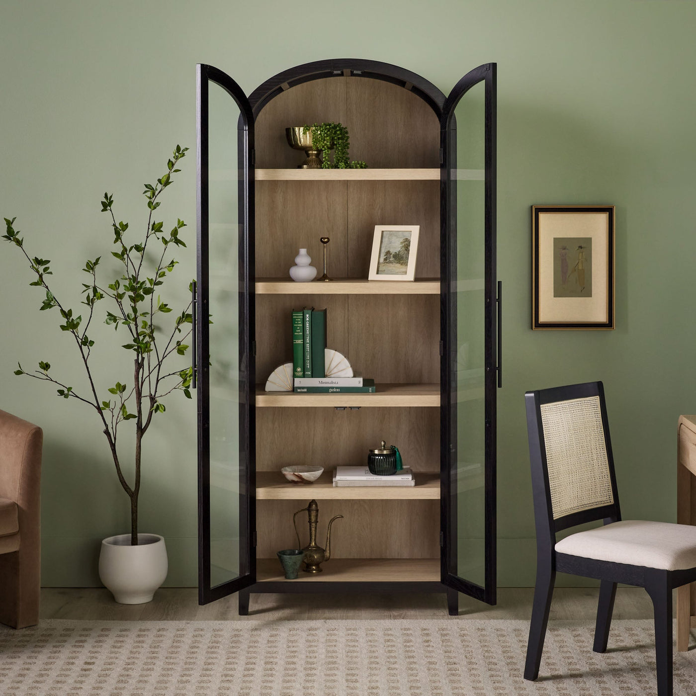 a glass cabinet with shelves and a chair in front of it