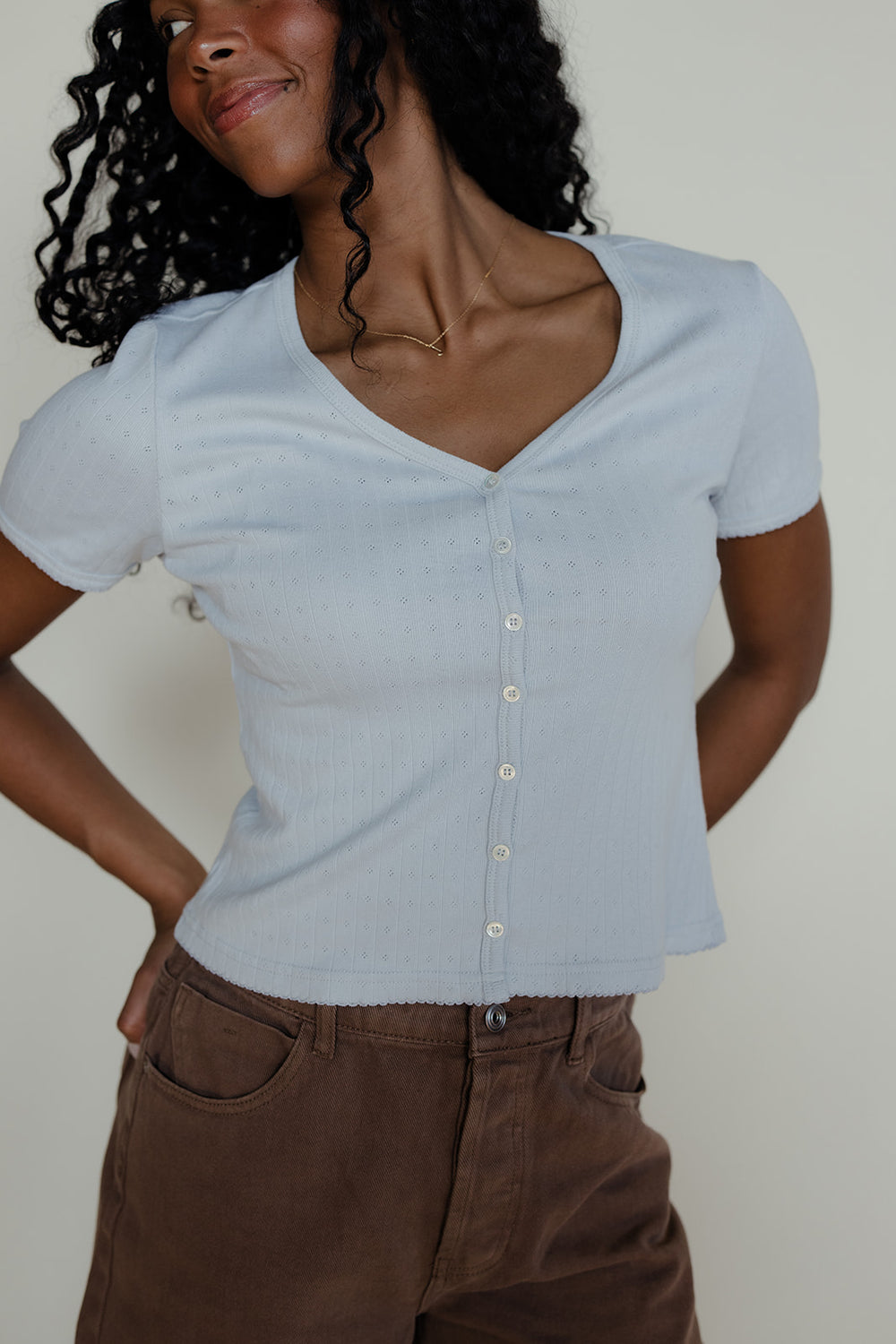 Woman wearing a blue button tee