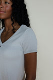Woman wearing a blue pointelle tee