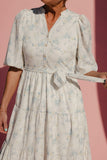Woman wearing a floral dress against a pink background