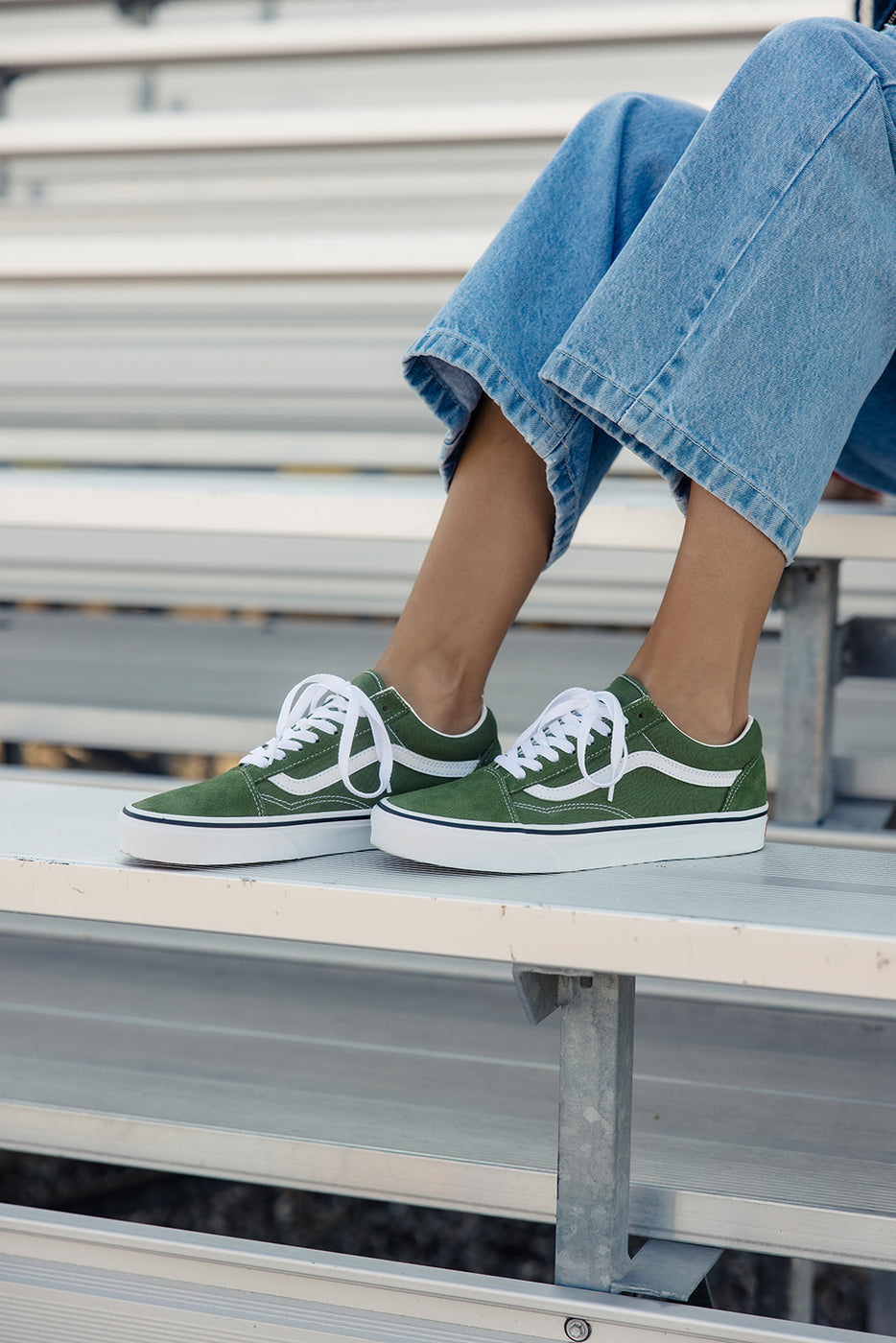 a person wearing green and white shoes