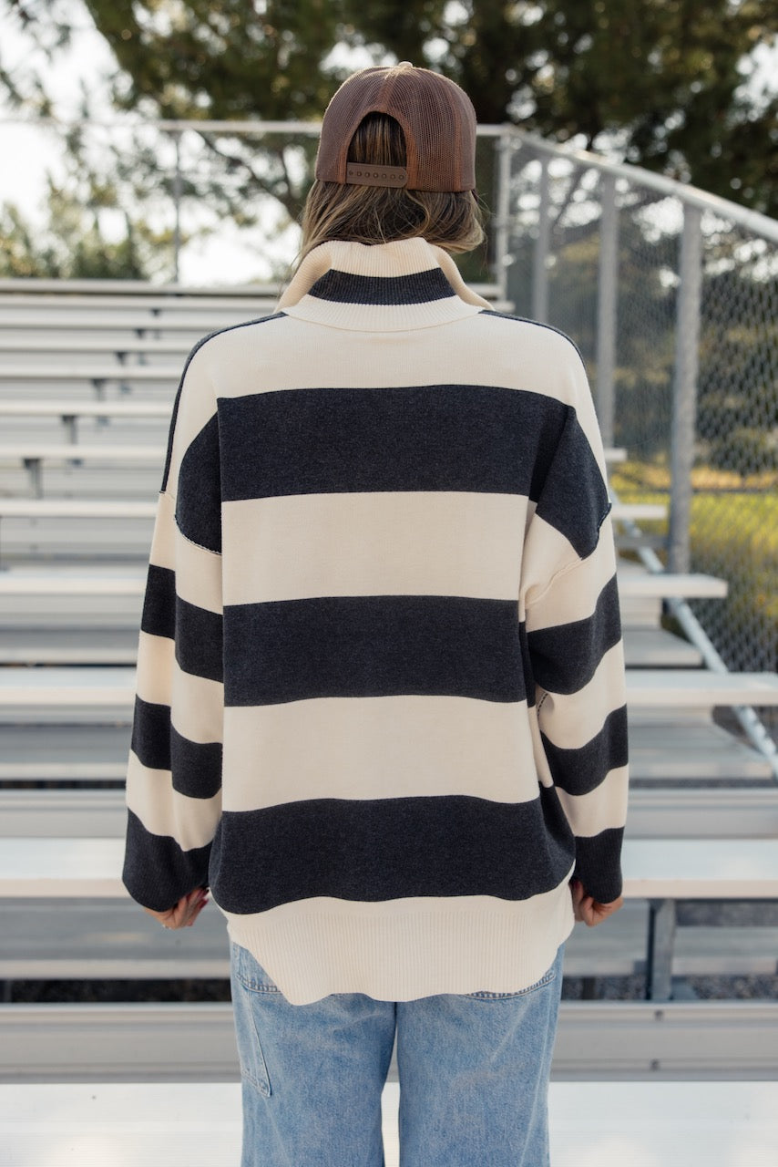 a woman in a striped sweater