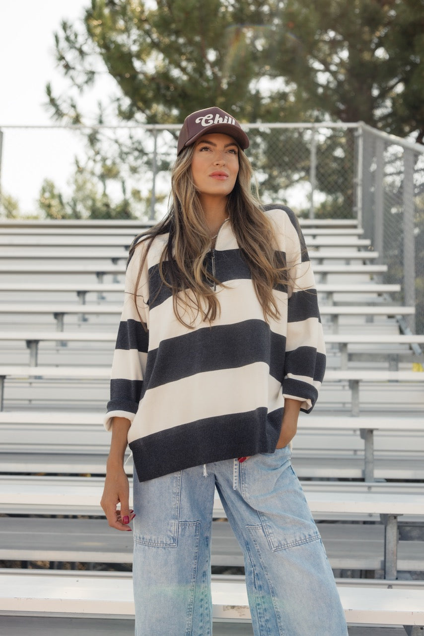 a woman standing in front of bleachers