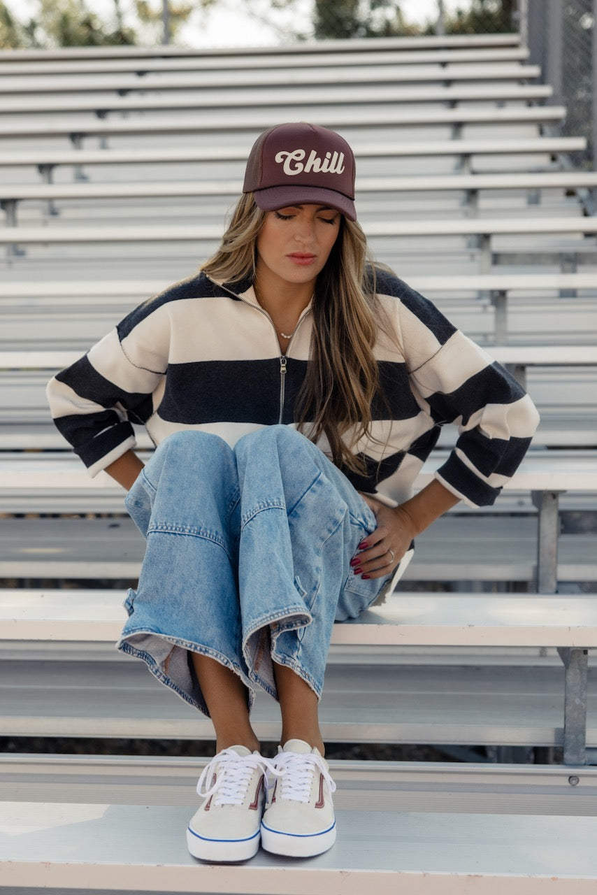 a woman sitting on bleachers