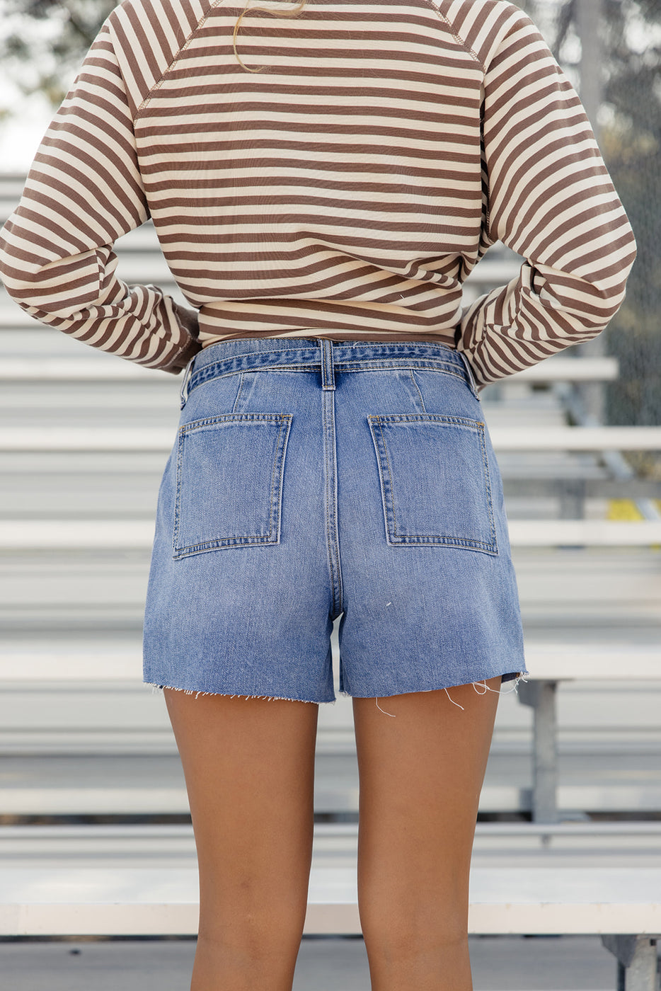 a woman in shorts with her hands on her hips