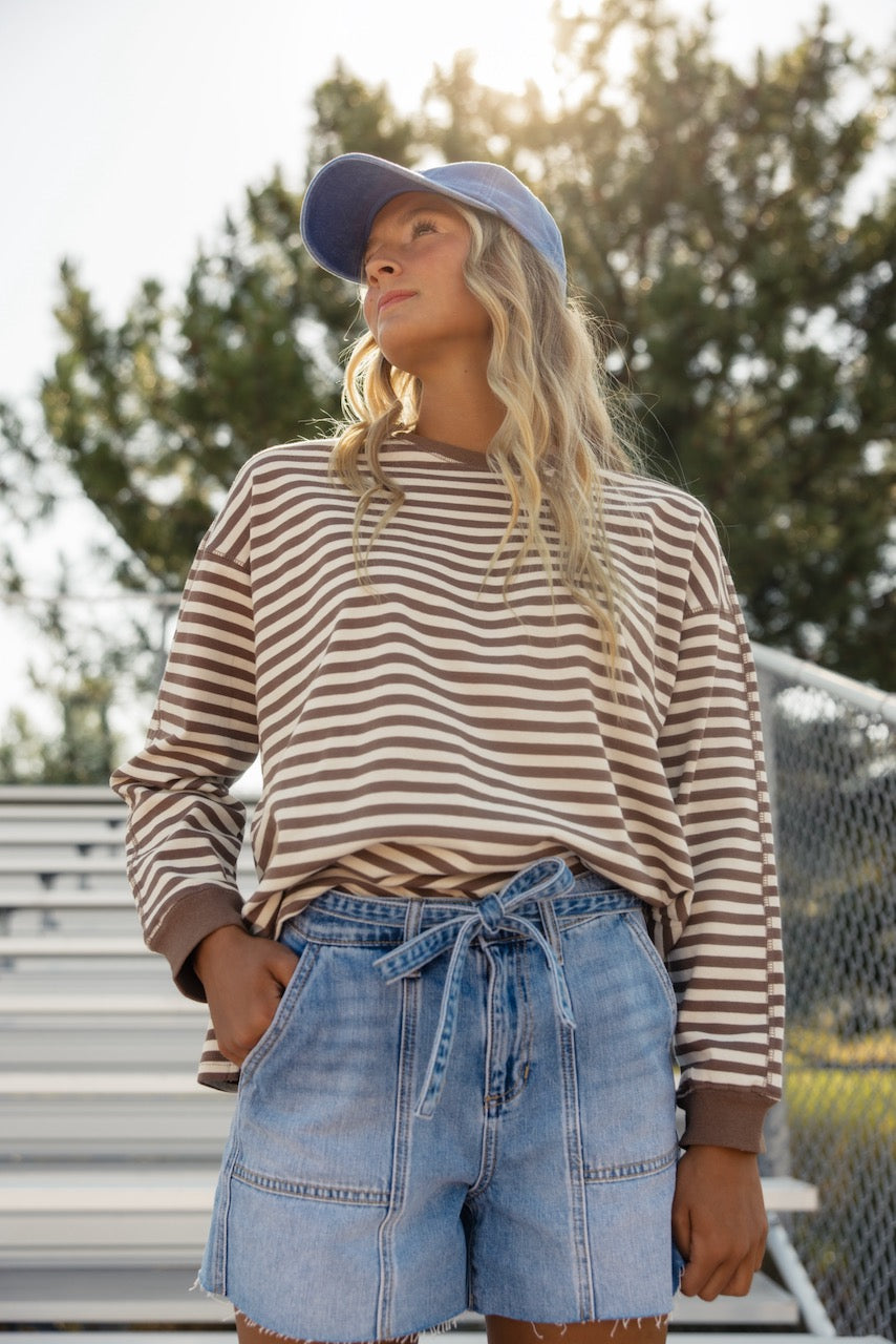 a woman wearing a hat and a striped shirt