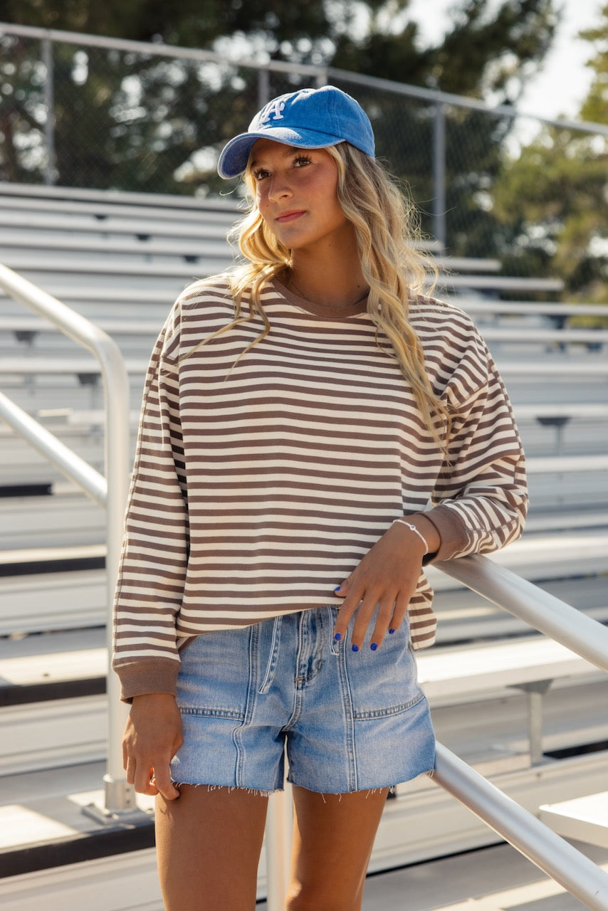 a woman wearing a blue hat and striped shirt