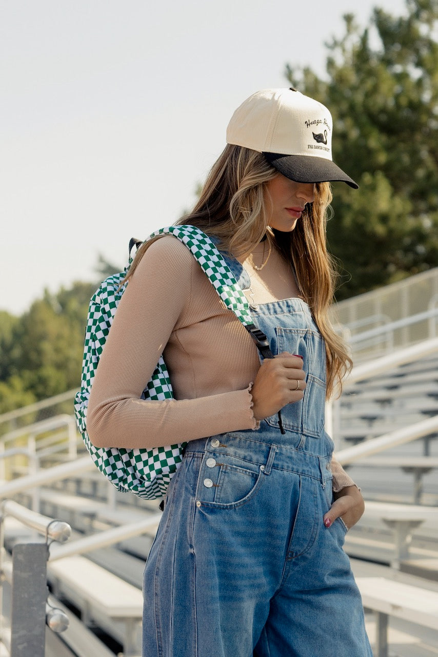 a woman wearing a hat and overalls