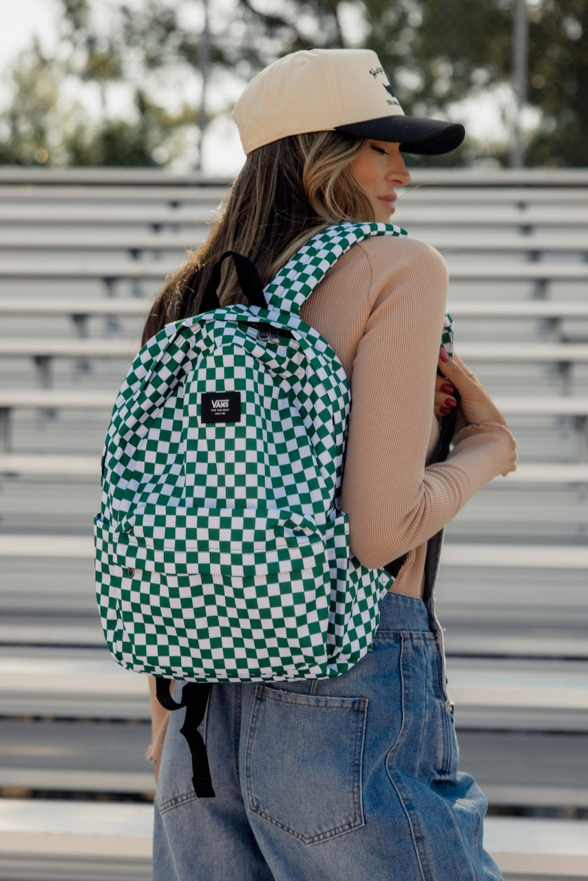 a woman wearing a hat and backpack