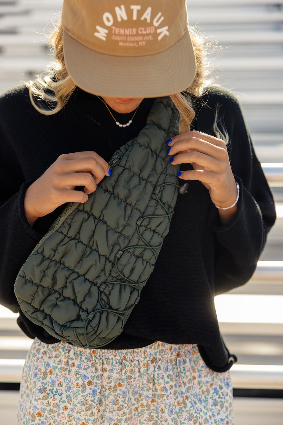 a woman holding a green bag