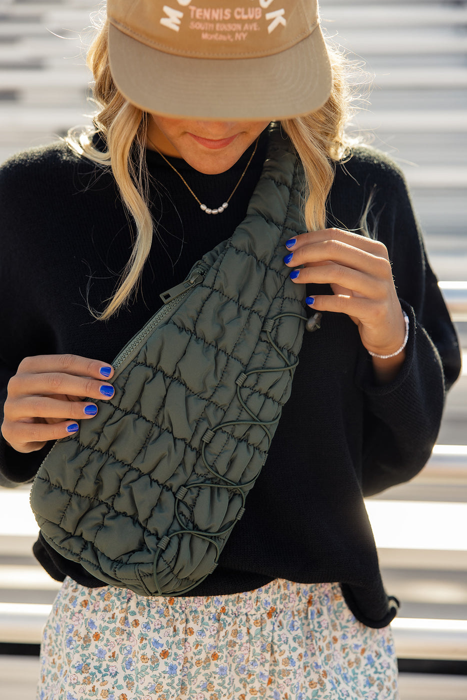 a woman holding a green bag