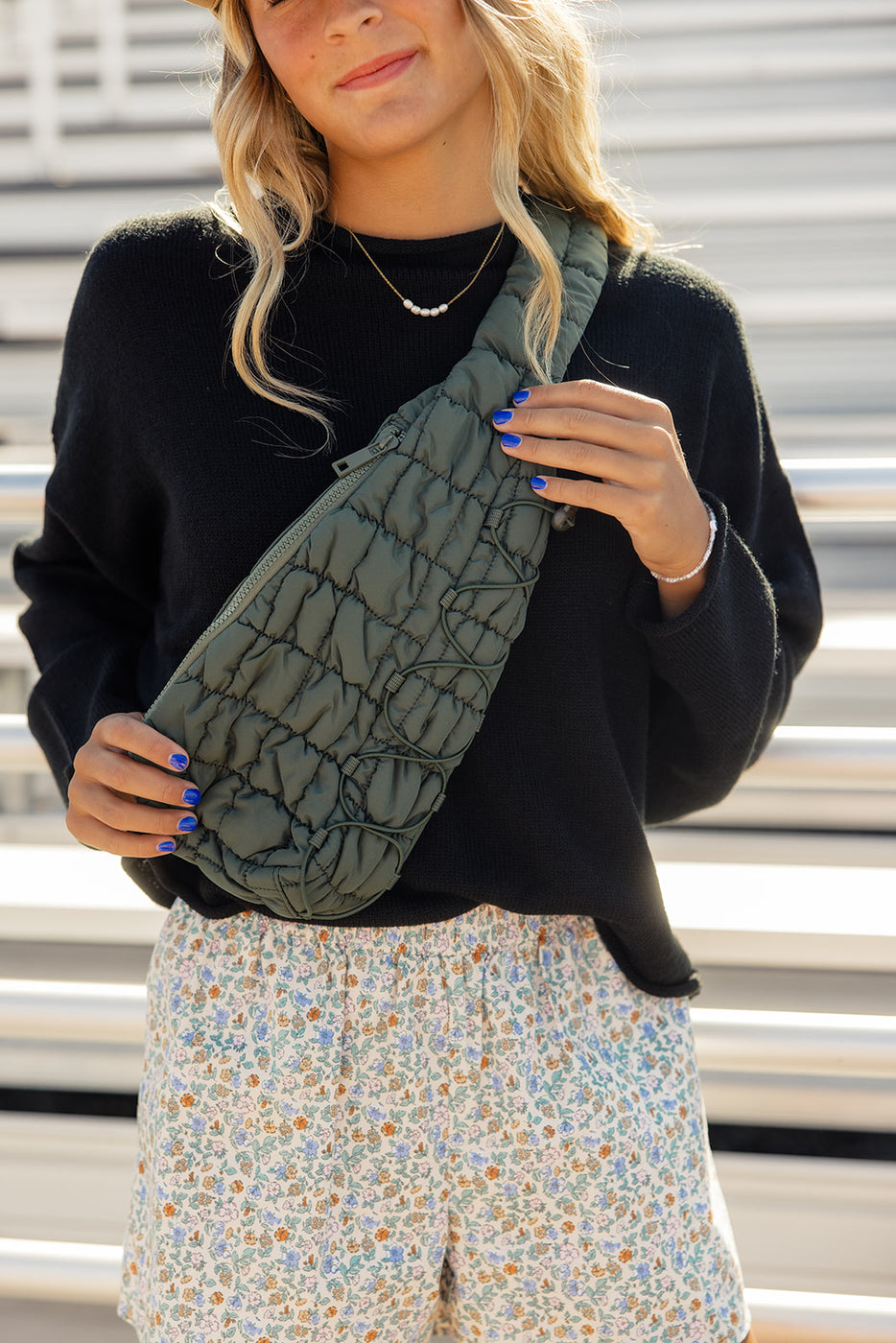 a woman holding a green bag