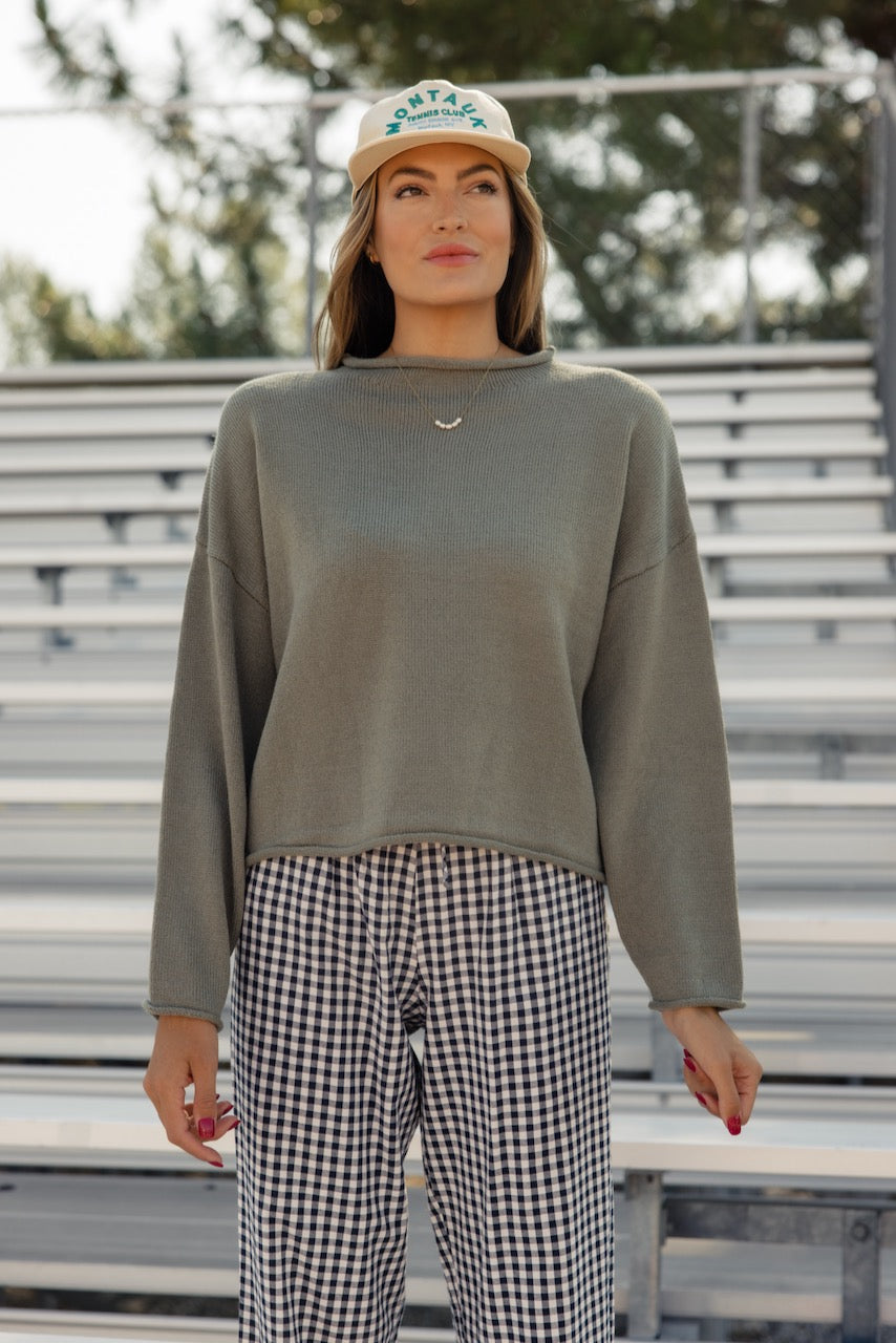 a woman standing in front of bleachers