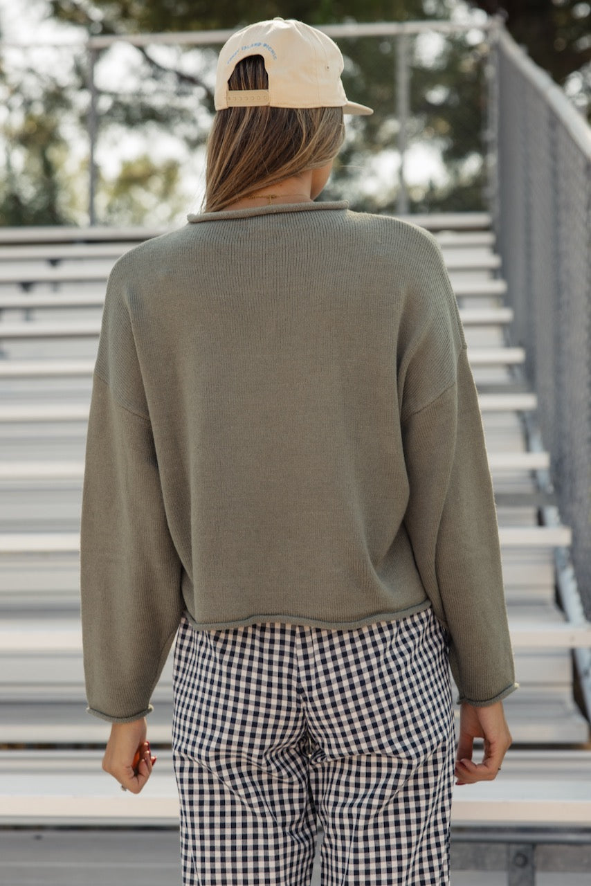 a woman standing on bleachers