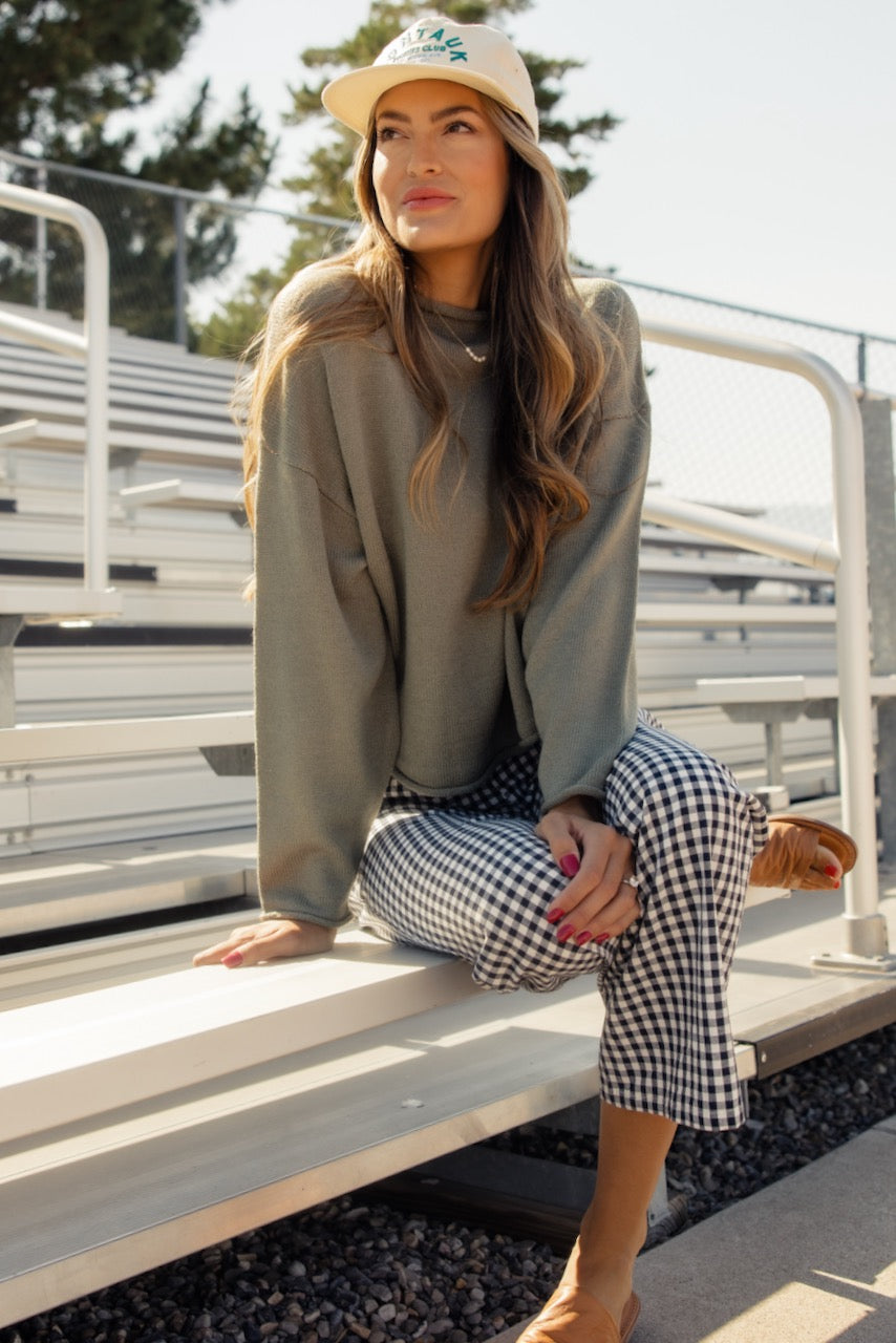 a woman sitting on bleachers