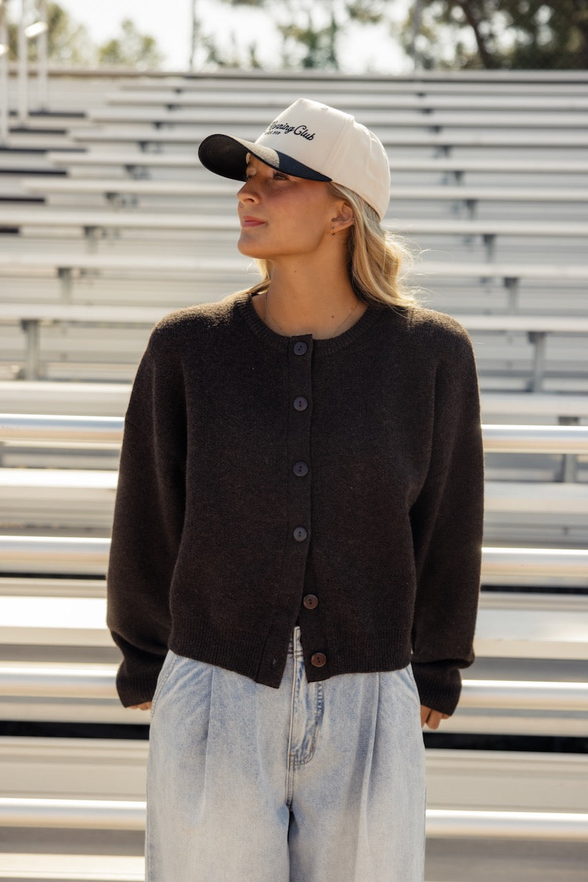 a woman wearing a hat and a sweater