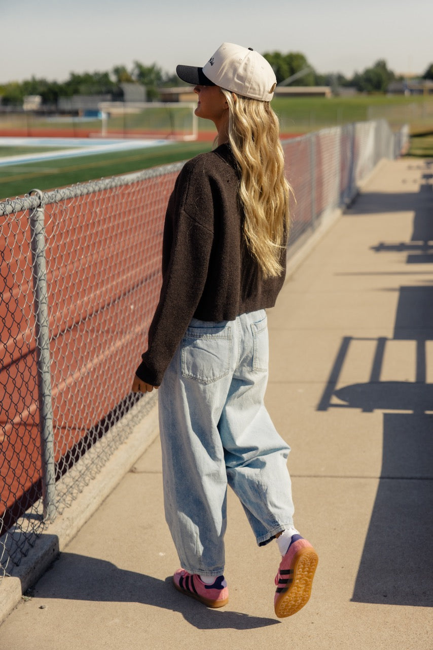 a woman standing on a sidewalk