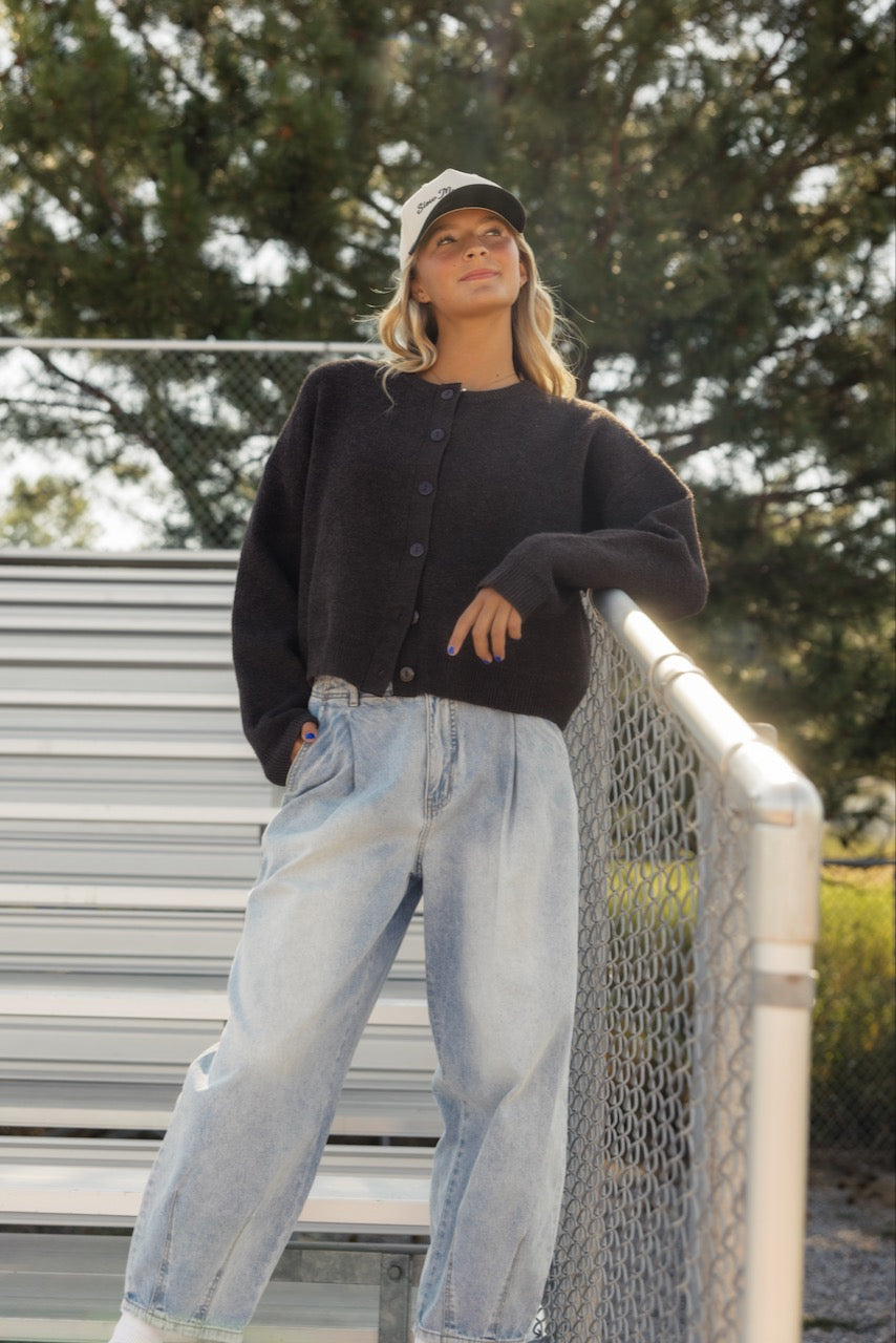 a woman leaning on a fence