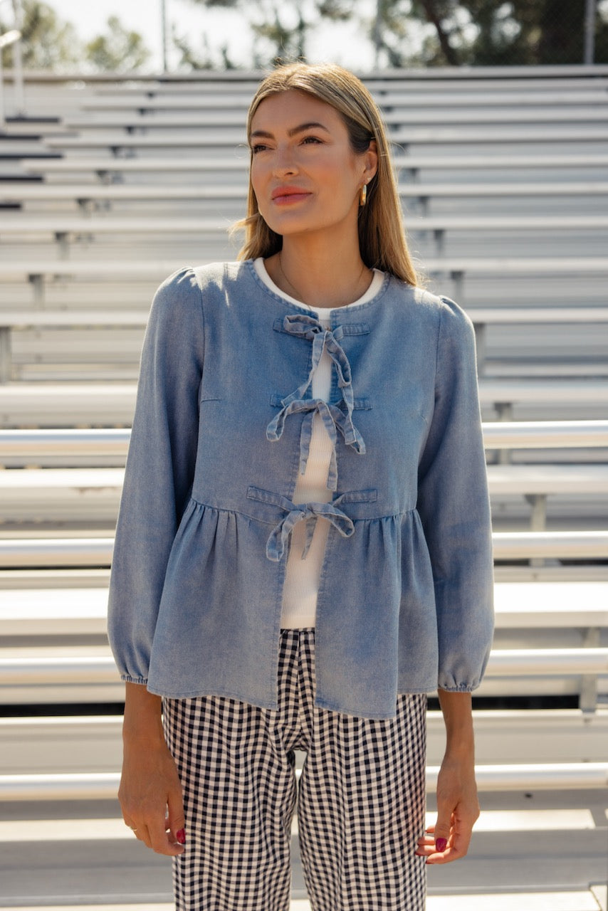 a woman standing in front of bleachers