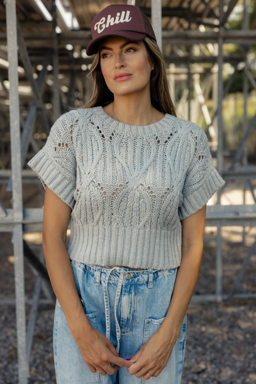 a woman standing in front of a metal structure