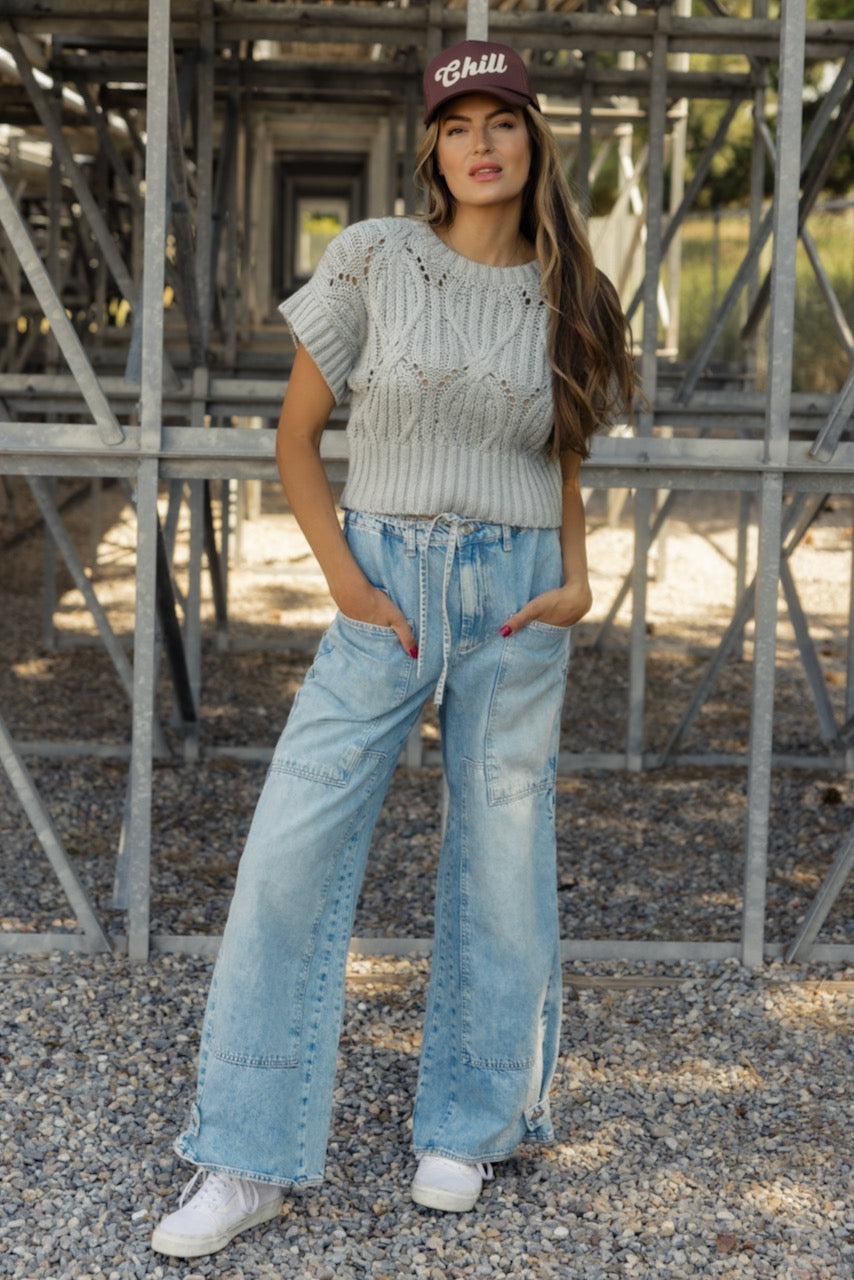 a woman standing in front of metal structure