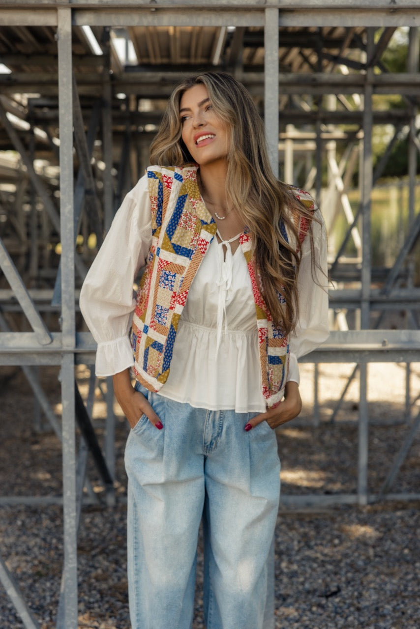 a woman standing in front of a metal structure