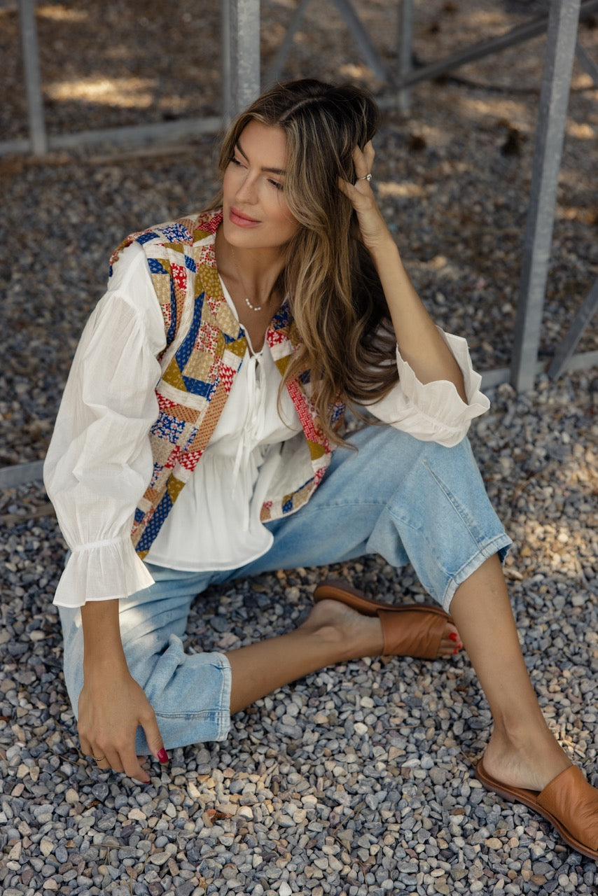 a woman sitting on gravel