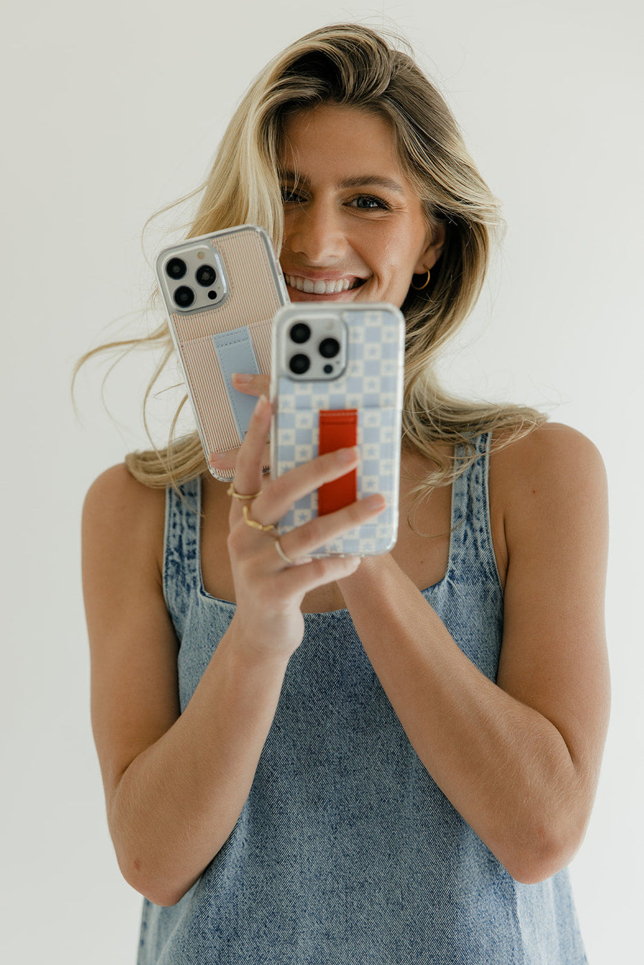 a woman holding two cell phones