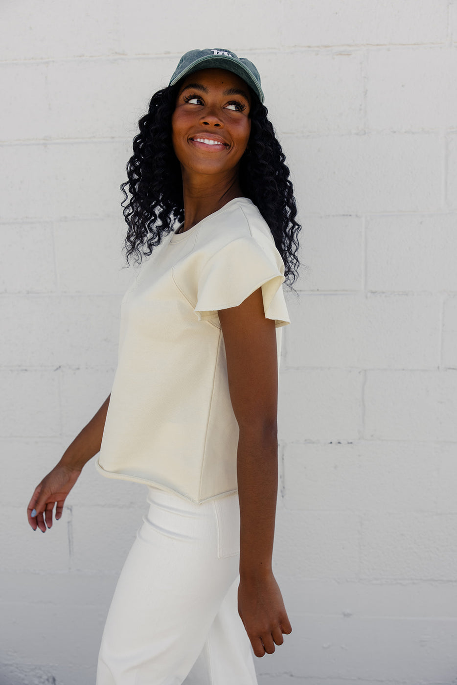 a woman smiling in a white shirt