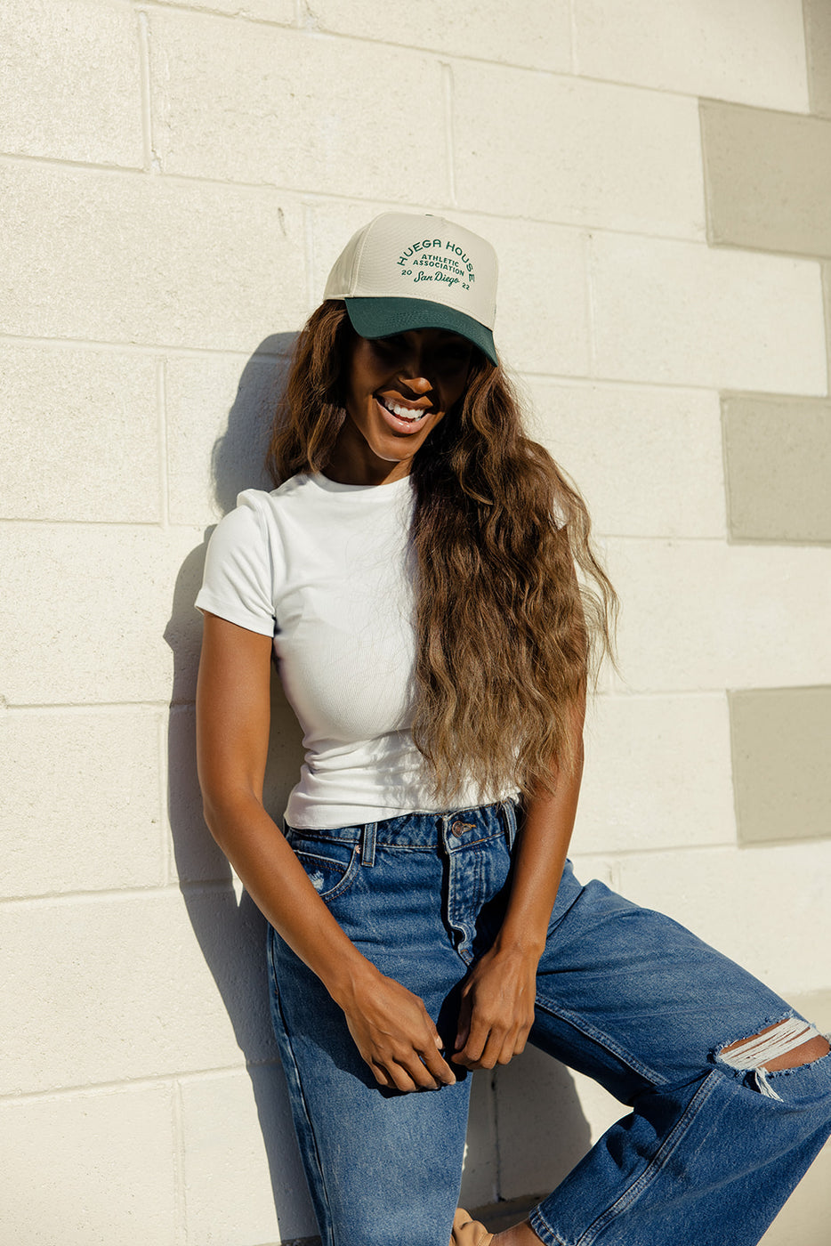 a woman wearing a hat and white shirt