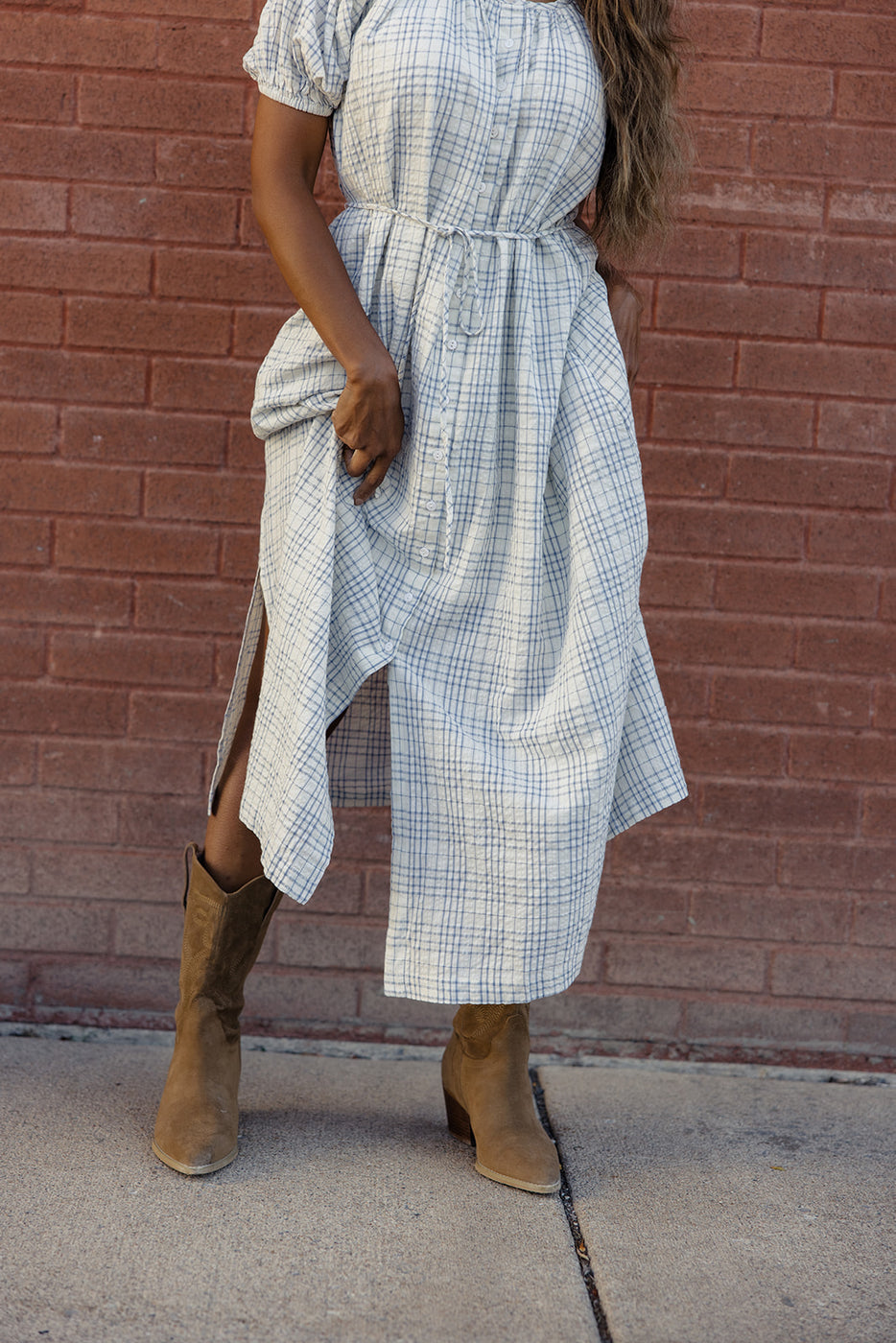 a woman wearing a dress and boots