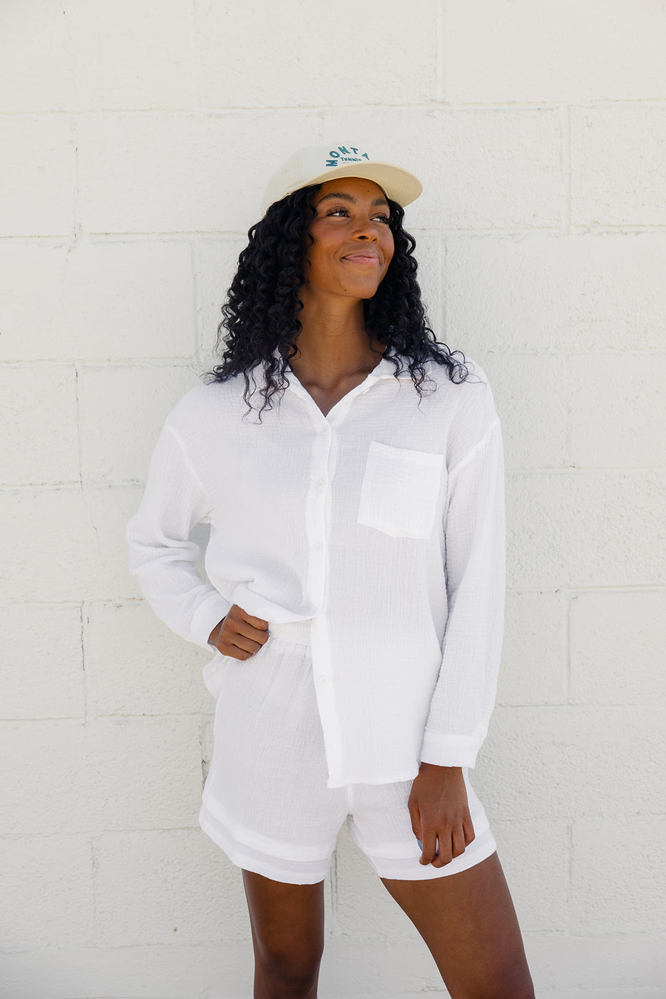 a woman in white outfit and hat