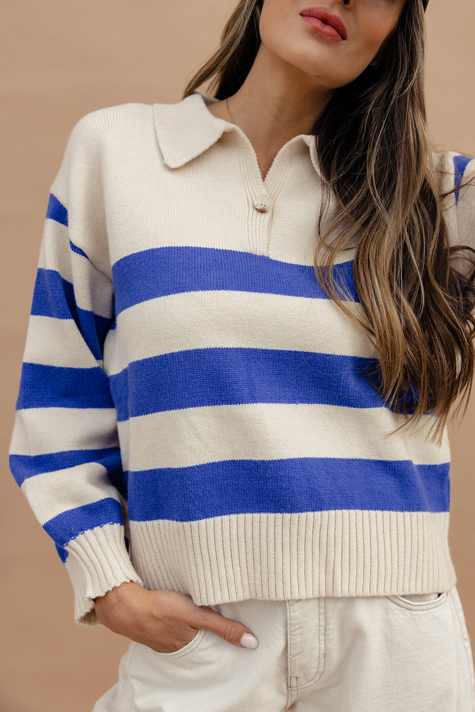 a woman wearing a blue and white striped shirt