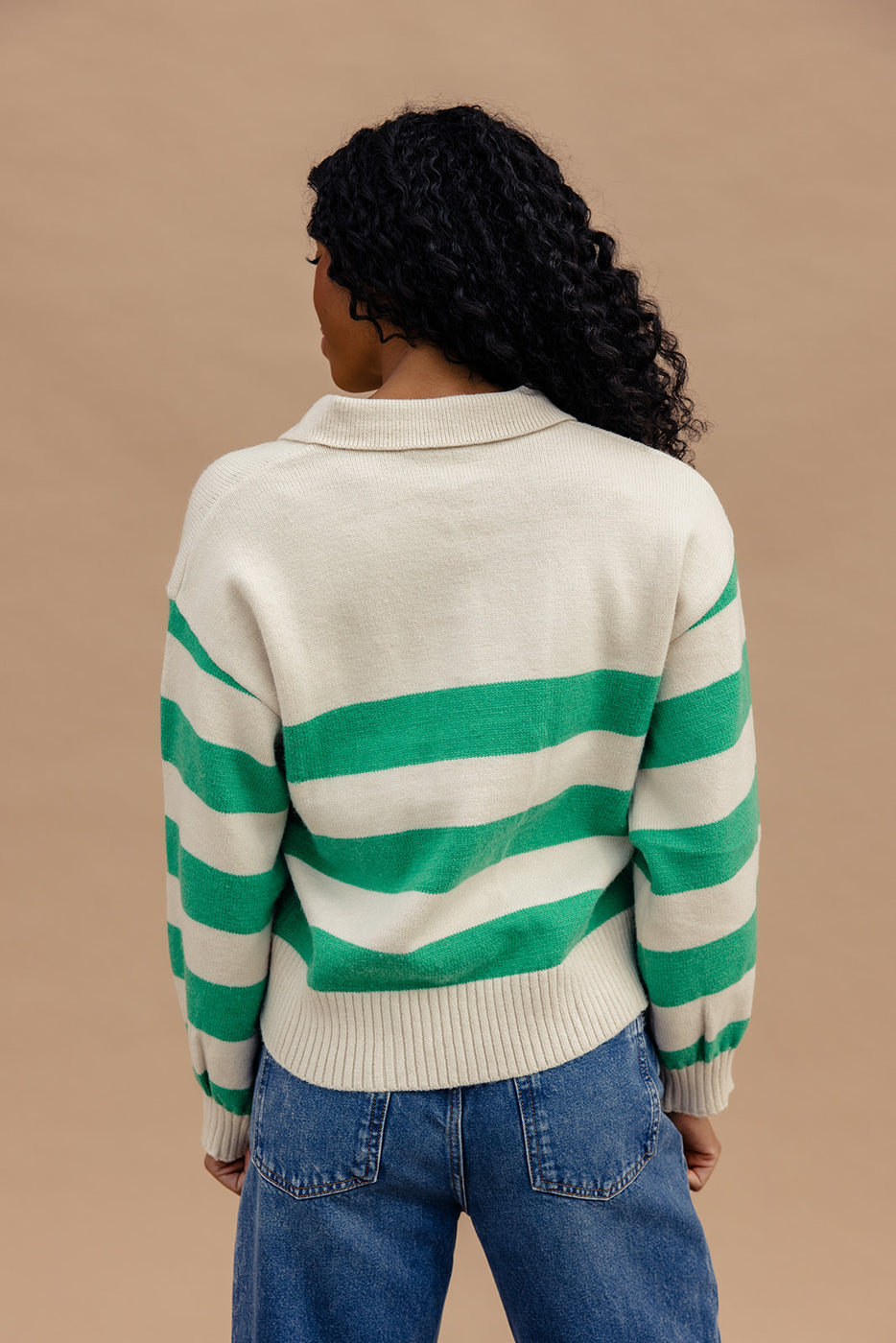 a woman wearing a green and white striped sweater