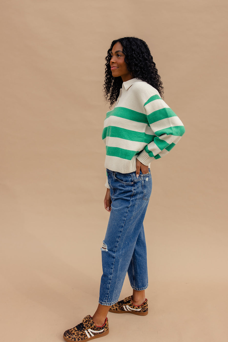 a woman in a striped sweater and jeans